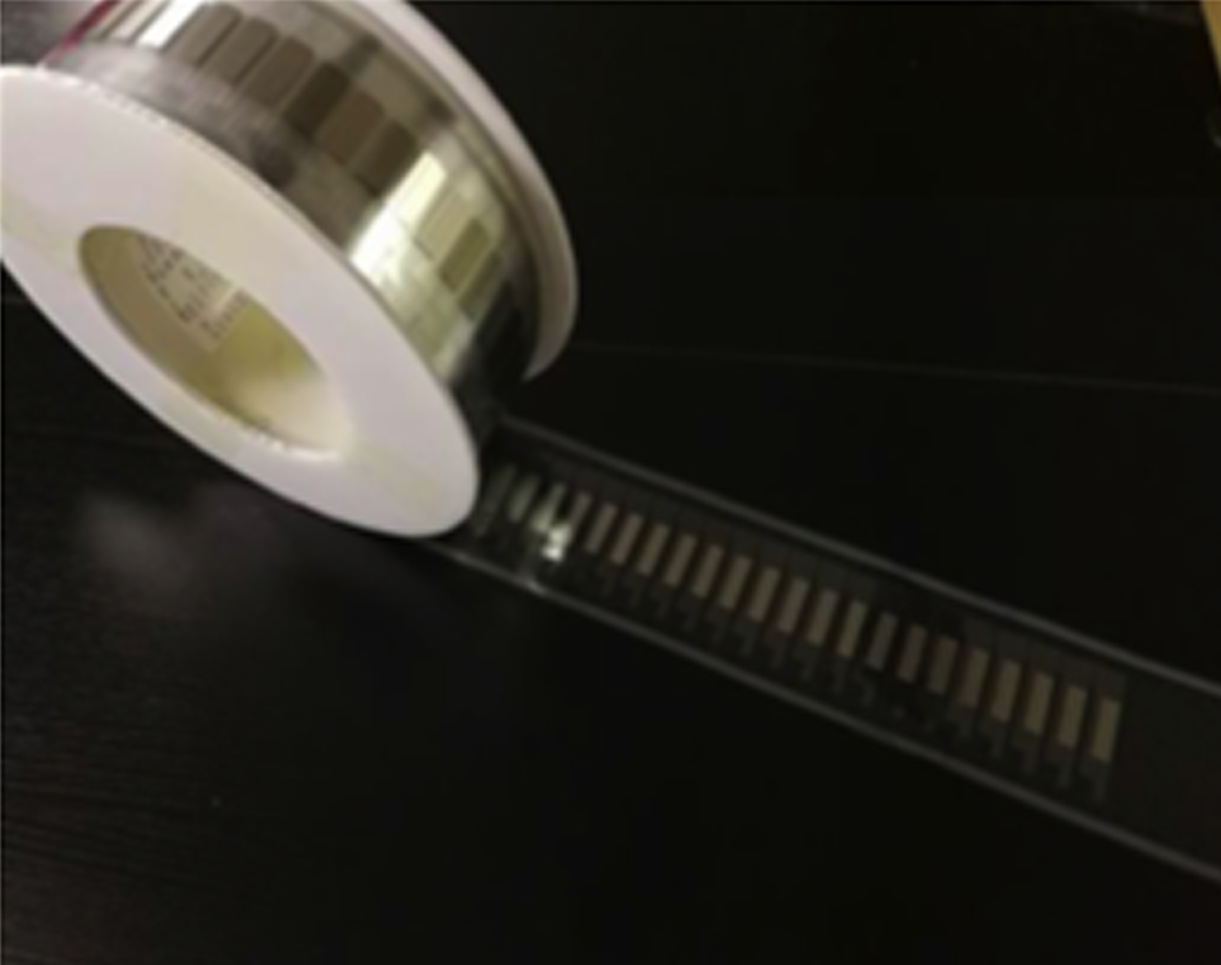 Etched steel sheet with adhesive